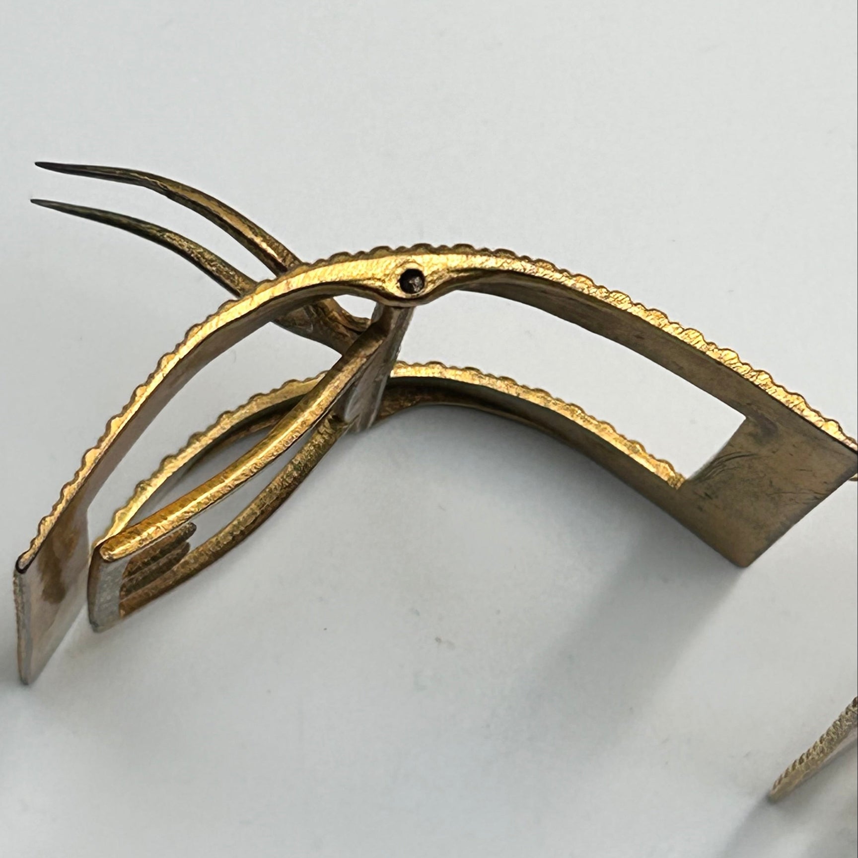 large antique gilt metal shoe buckle on side prongs out on white background  - Splendid Vintage World