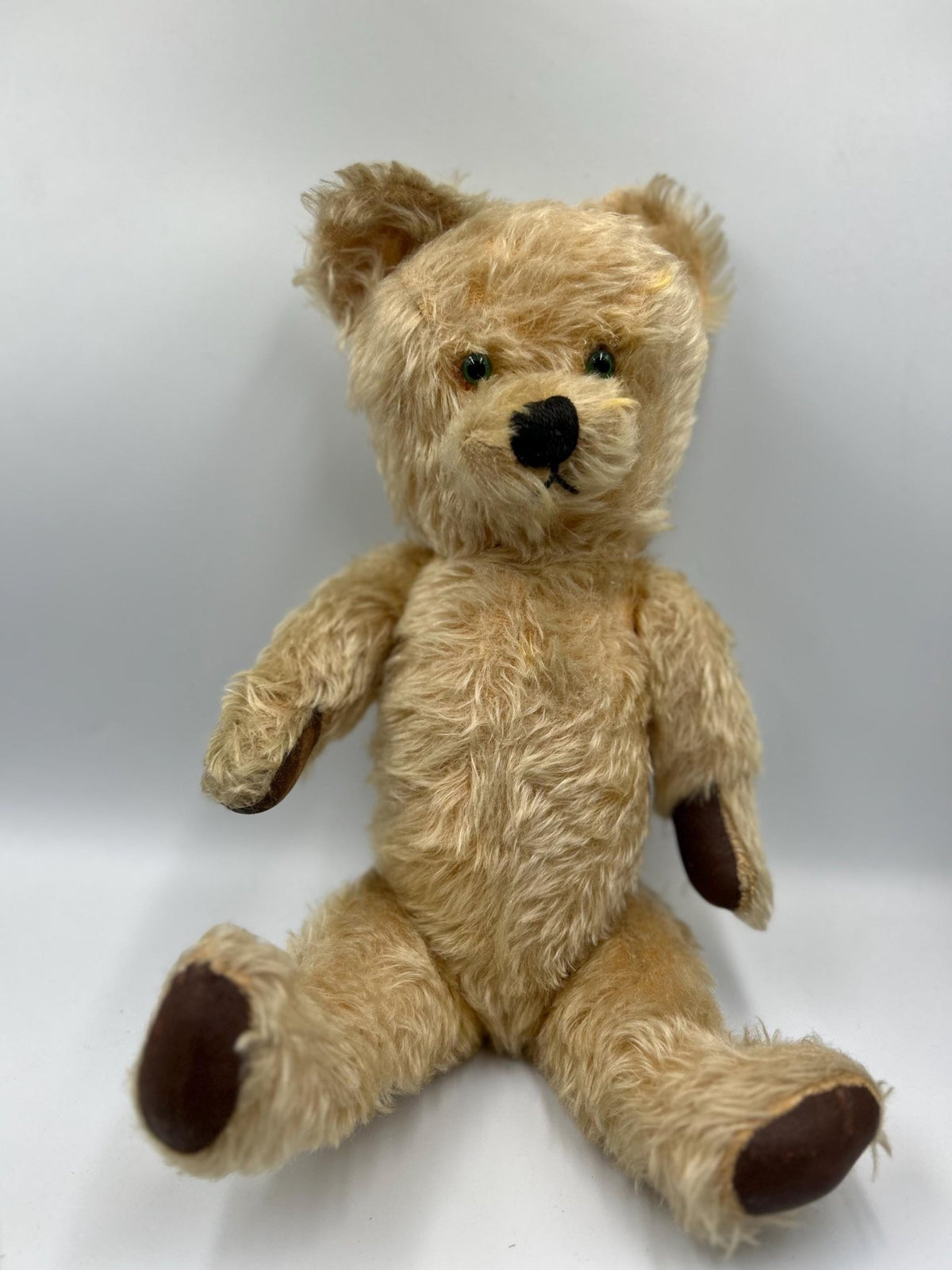 Vintage teddy bear jointed care worn green eyes on light grey background - Splendid Vintage World