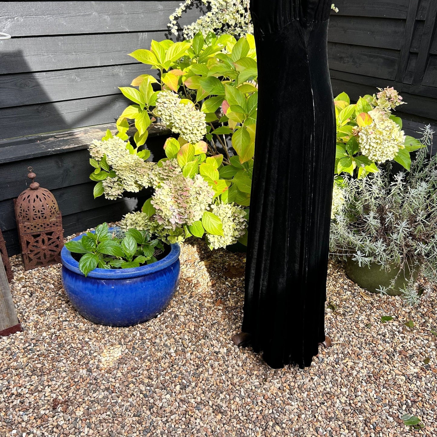 black velvet dress skirt on mannequin on gravel in garden - Splendid Vintage World