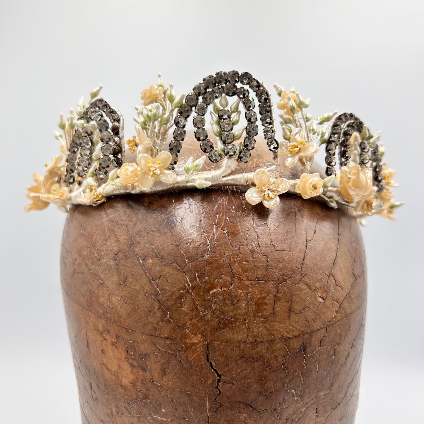 bridal crown tiara of diamanté adornments, wax flowers & buds on wooden hat block on white ground - Splendid Vintage World