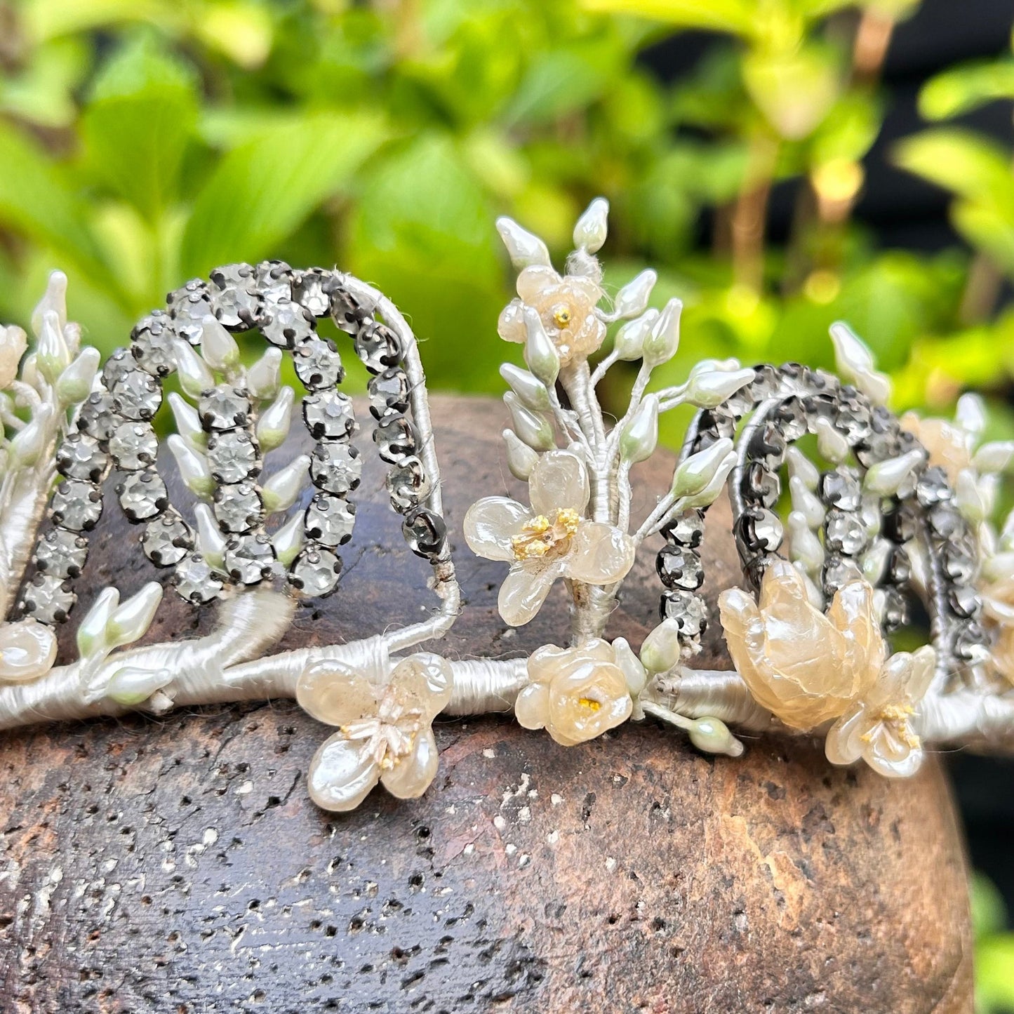 Vintage bridal crown tiara of diamanté, wax flowers & buds on wooden head with greenery background - Splendid Vintage World