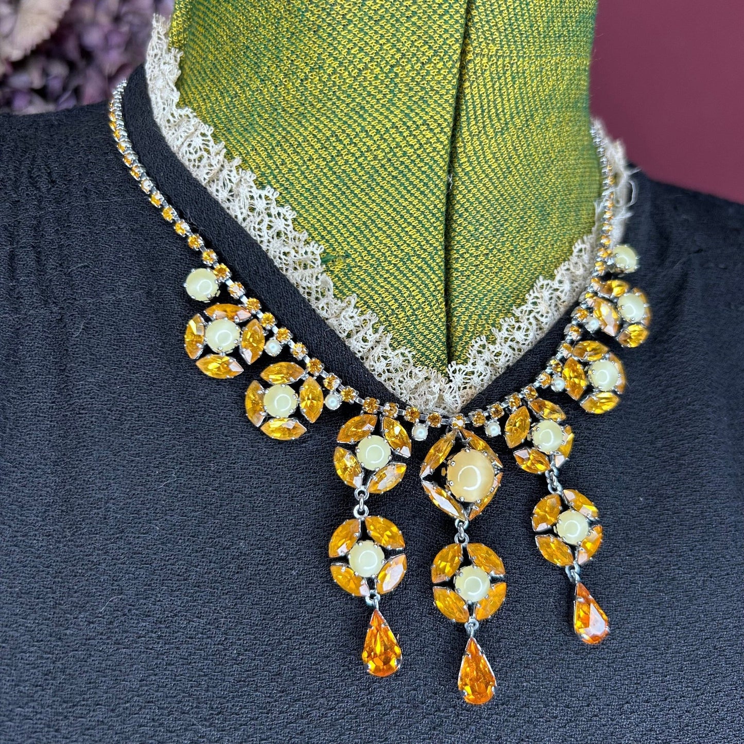 Citrine colour Necklace With Floral Droplets & Faux Pearls over black dress on green mannequin - Splendid Vintage World
