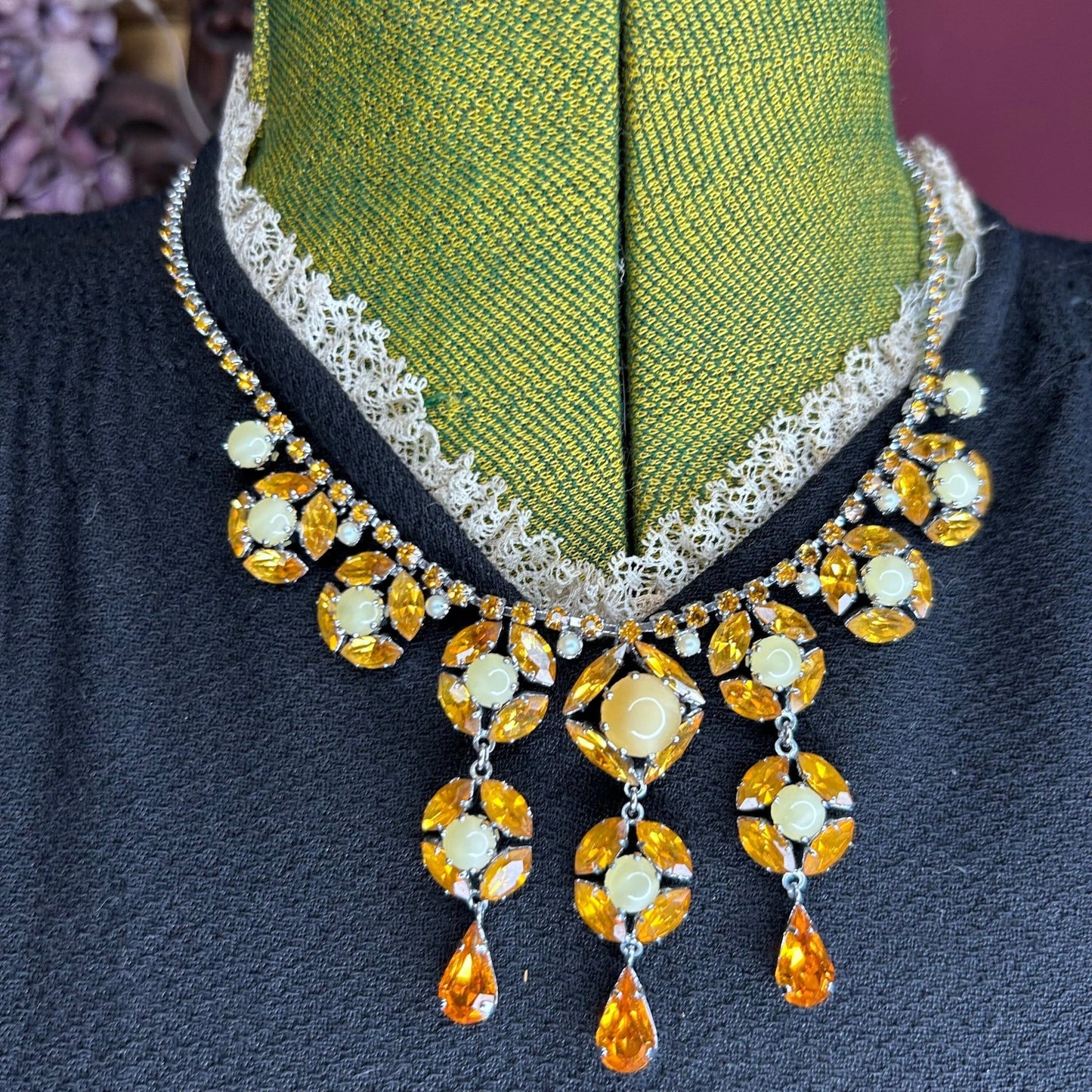 Citrine colour Necklace With Floral Droplets & Faux Pearls over black dress on green mannequin - Splendid Vintage World