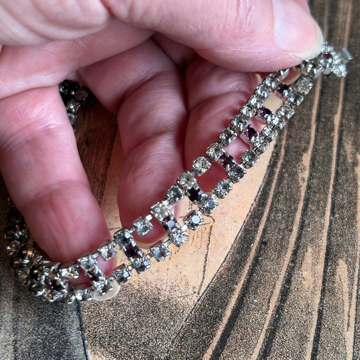 Vintage diamanté bracelet clear & amethyst paste held by hand on printed background- Splendid Vintage World