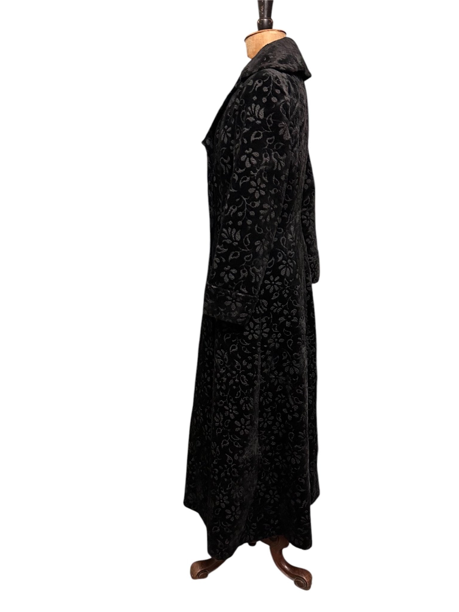 side view of black long floral velvet coat fit & flare Edwardian style against white background - Splendid Vintage World