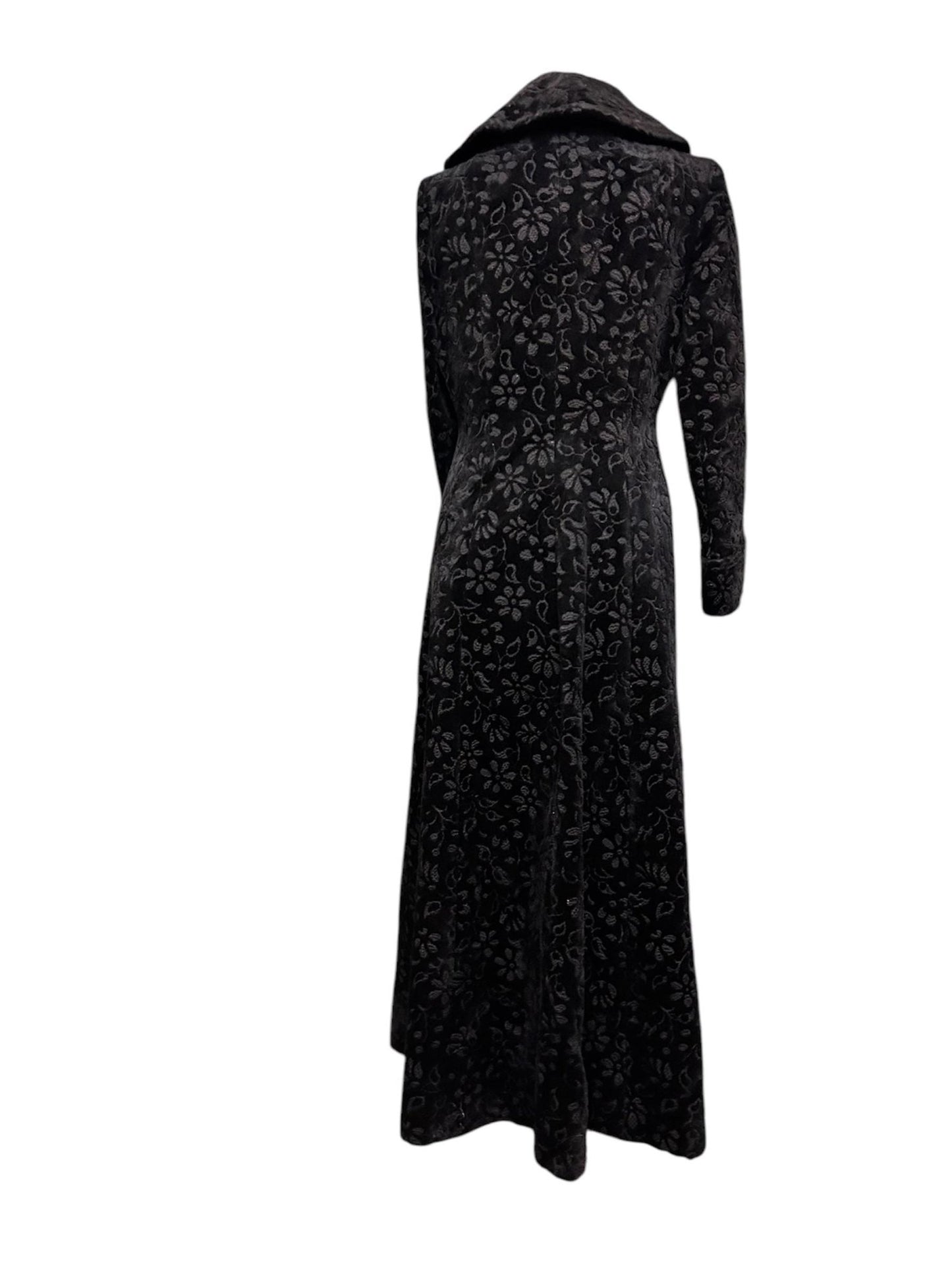 back view of black long floral velvet coat fit & flare victorian Edwardian style with white backdrop - Splendid Vintage World