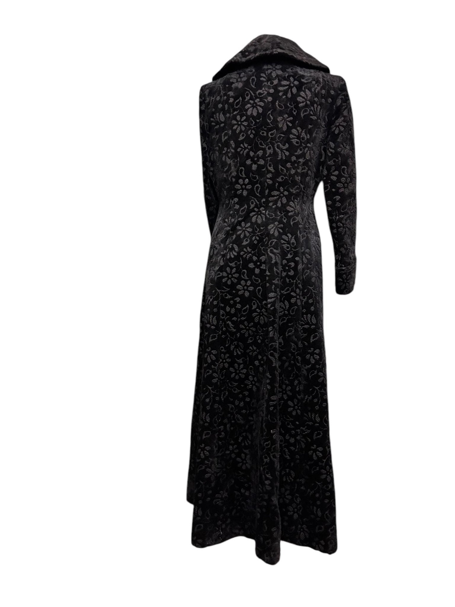 back view of black long floral velvet coat fit & flare victorian Edwardian style with white backdrop - Splendid Vintage World