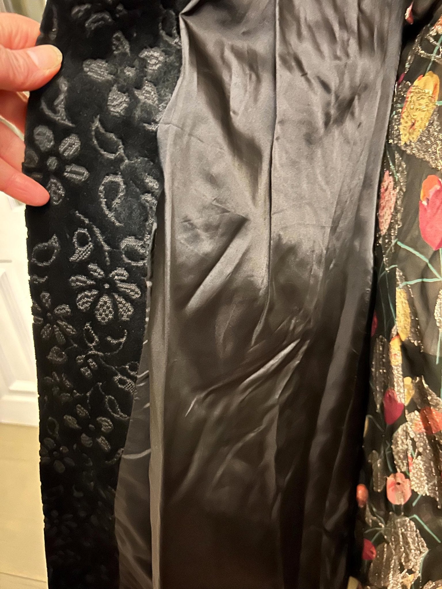 Vintage floral velvet coat section showing black satin lining held by hand- Splendid Vintage World