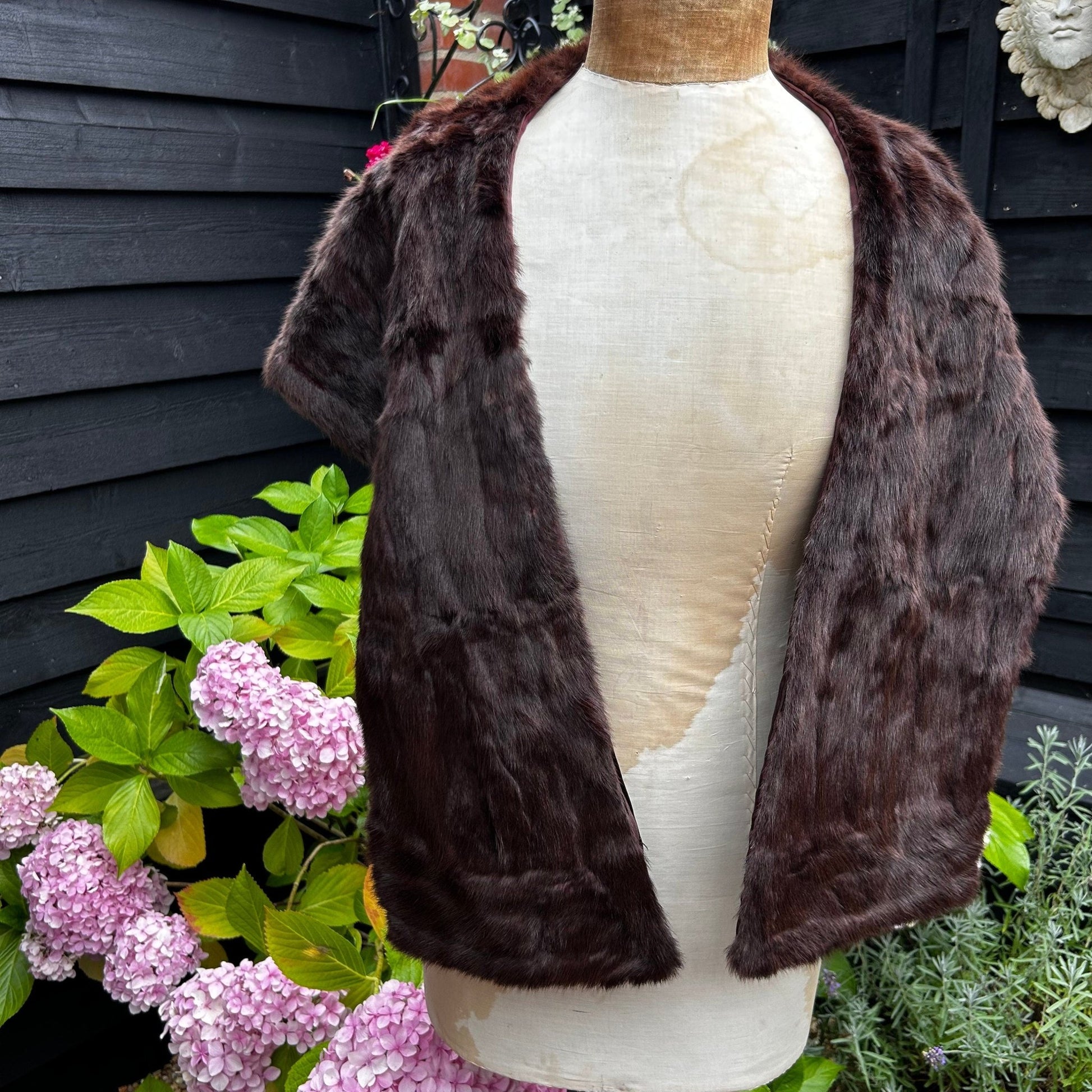 back view of Vintage Fur Stole Reddish Brown in colour on a mannequin in a garden - Splendid Vintage World
