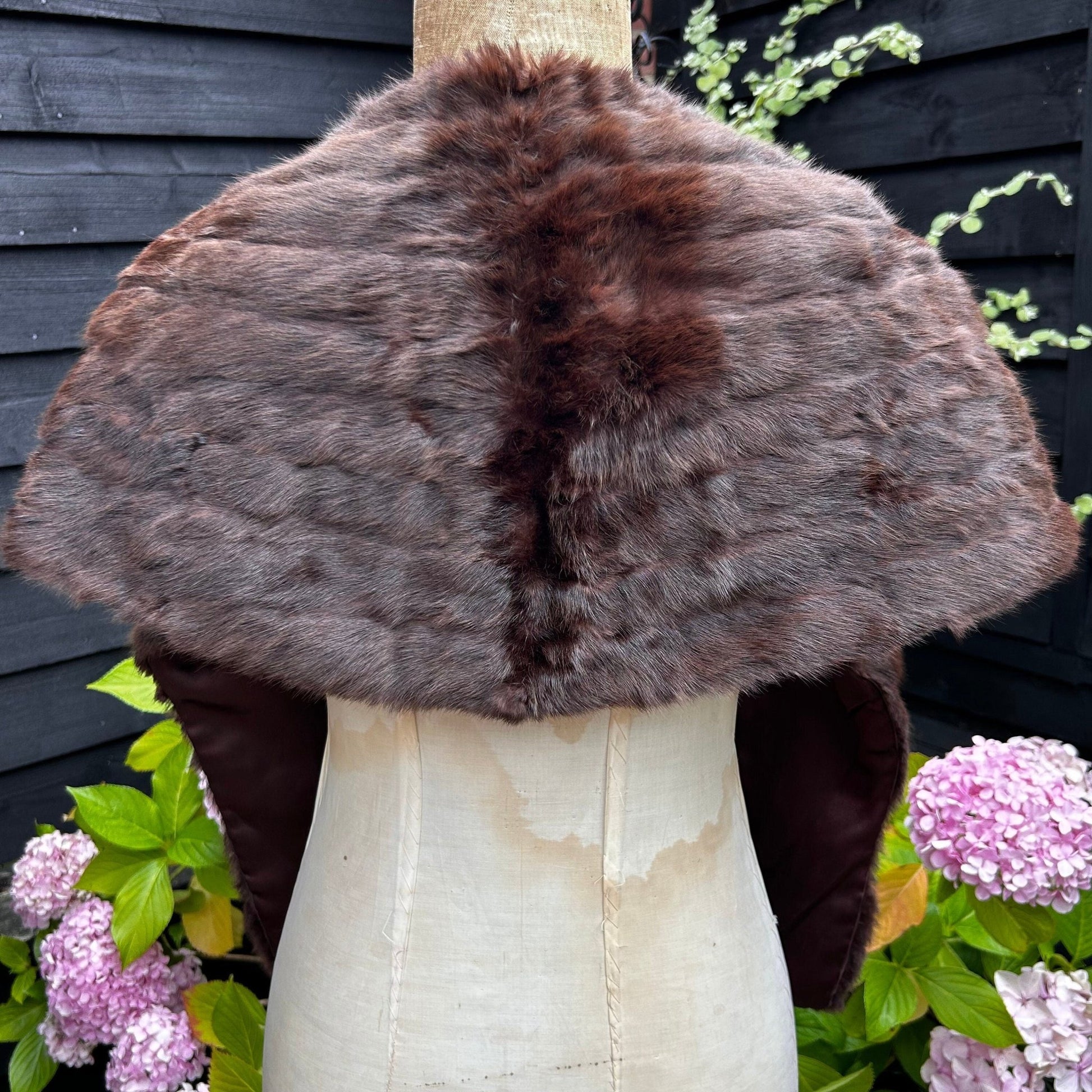 back view of Vintage Fur Stole Reddish Brown in colour on a mannequin in a garden - Splendid Vintage World