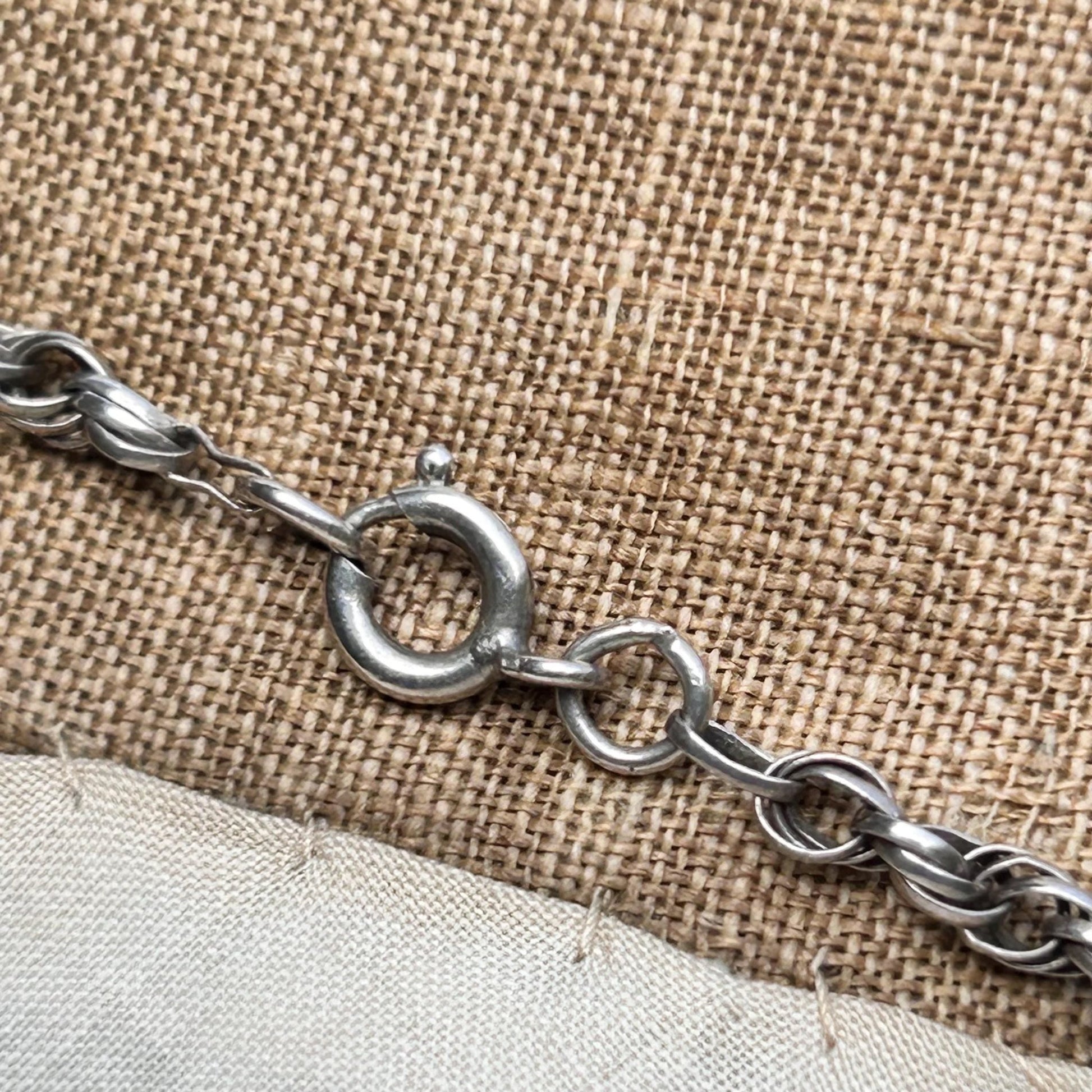 close up of silver rope chain bolt ring fastener on mannequin - Splendid Vintage World