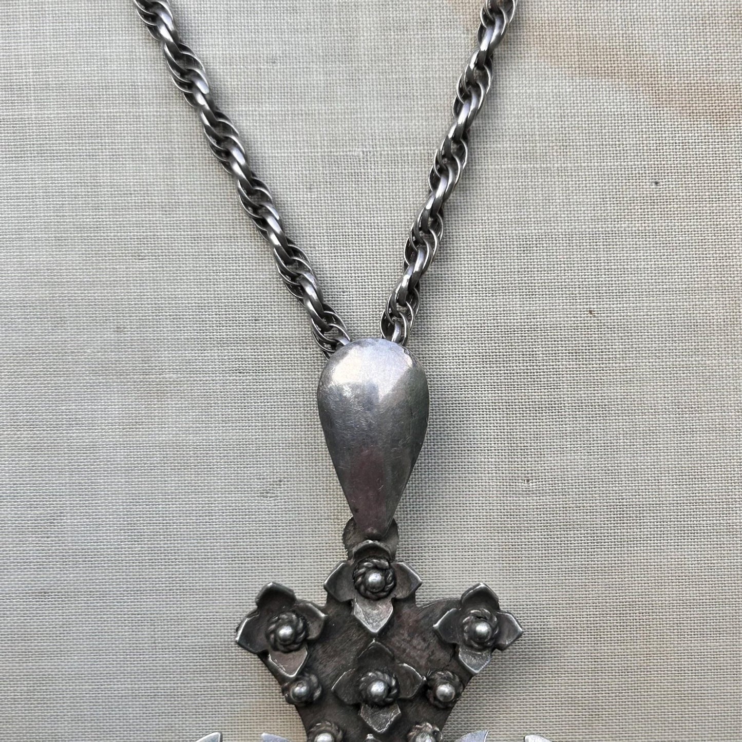 close up of silver  pendant hanger & silver rope chain on beige background - Splendid Vintage World