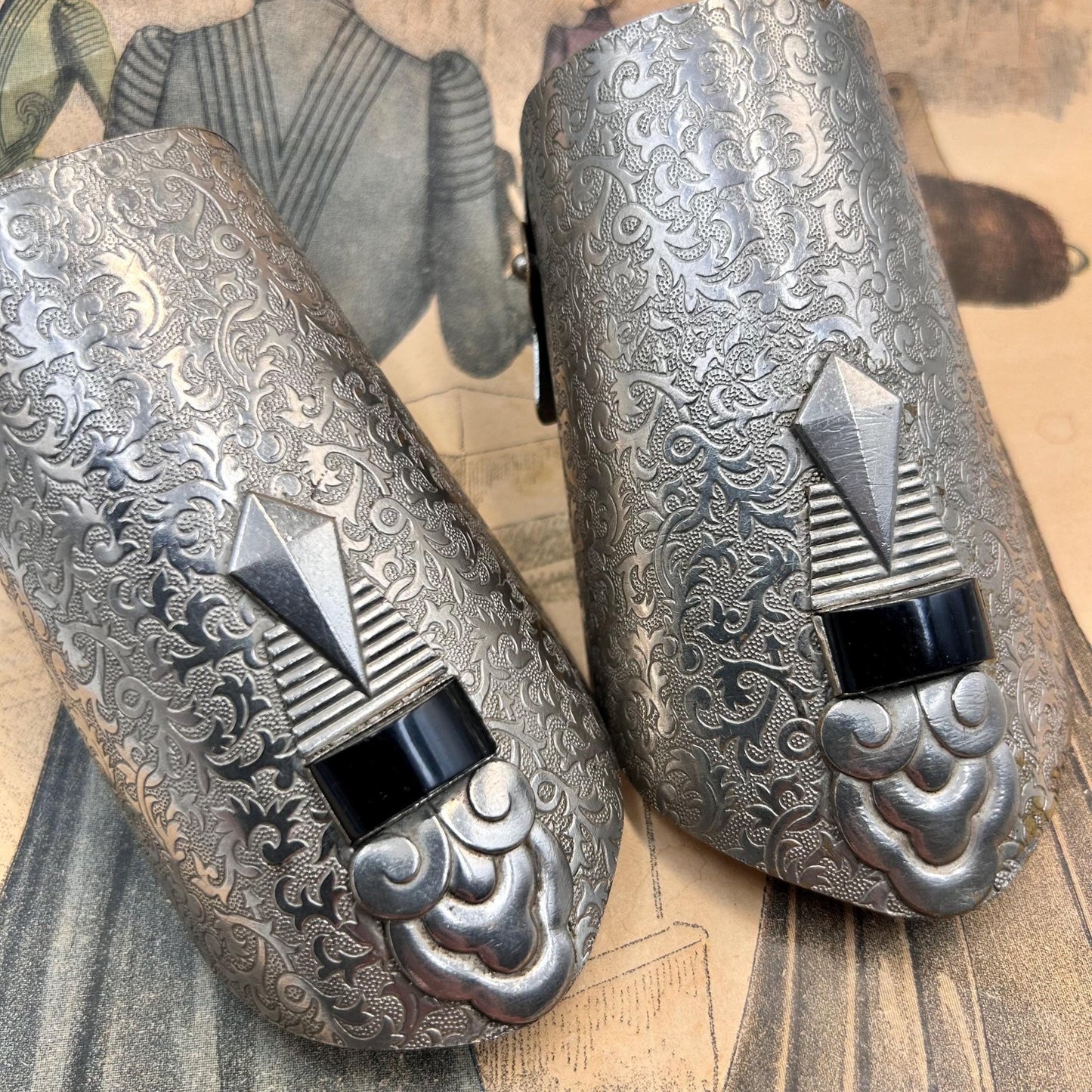 Pair of Vintage Art Deco style metal cuffs or bracelets with etched foliage pattern & applied metal & black glass detailing