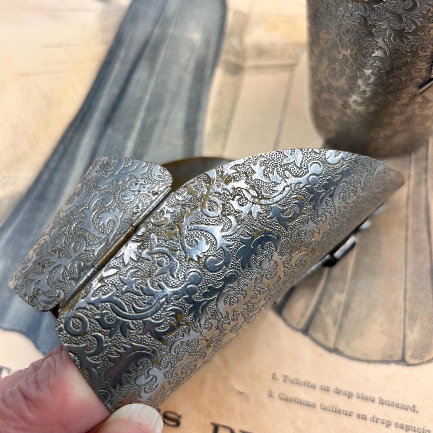 Pair of Vintage Art Deco style metal cuffs or bracelets with etched foliage pattern & applied metal & black glass detailing