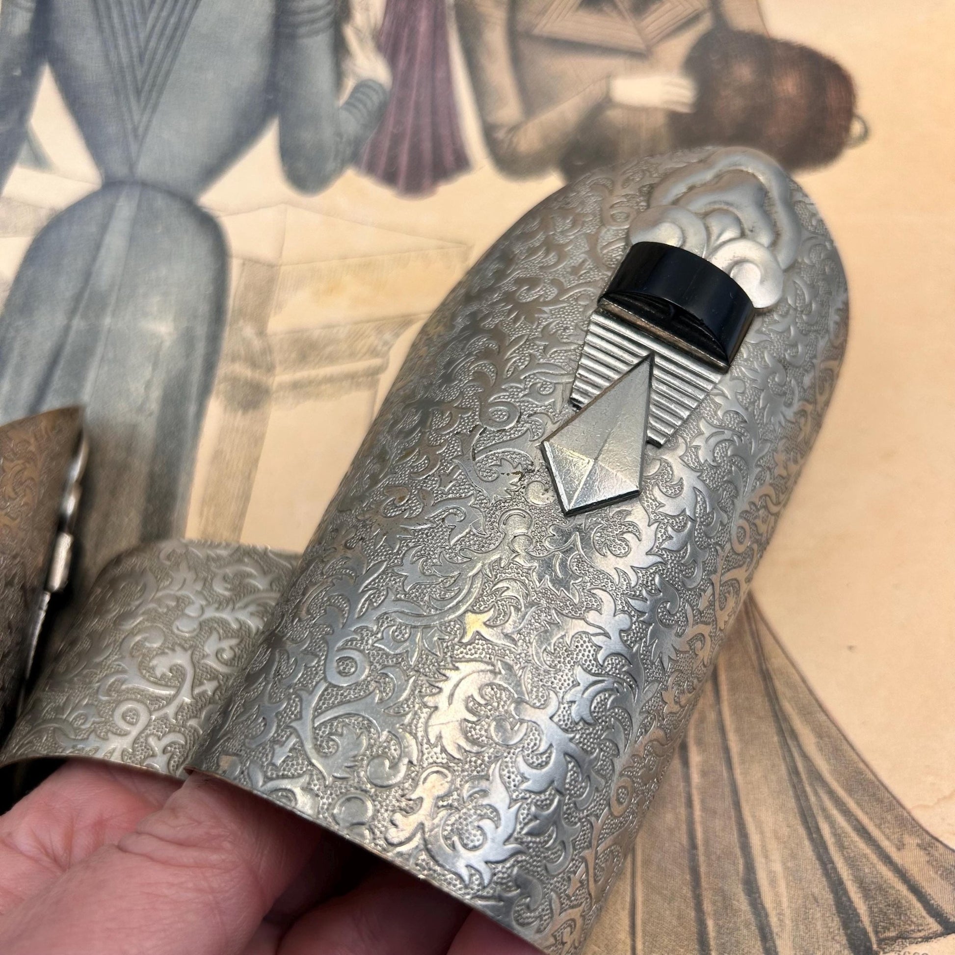 Pair of Vintage Art Deco style metal cuffs or bracelets with etched foliage pattern & applied metal & black glass detailing