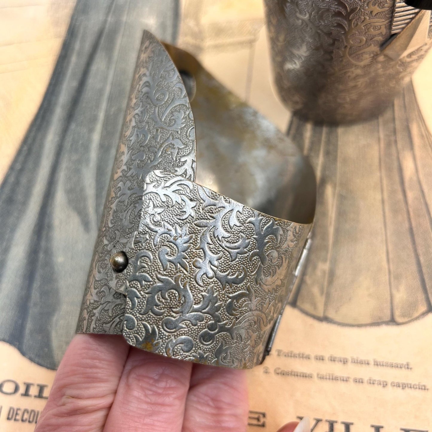 Pair of Vintage Art Deco style metal cuffs or bracelets with etched foliage pattern & applied metal & black glass detailing