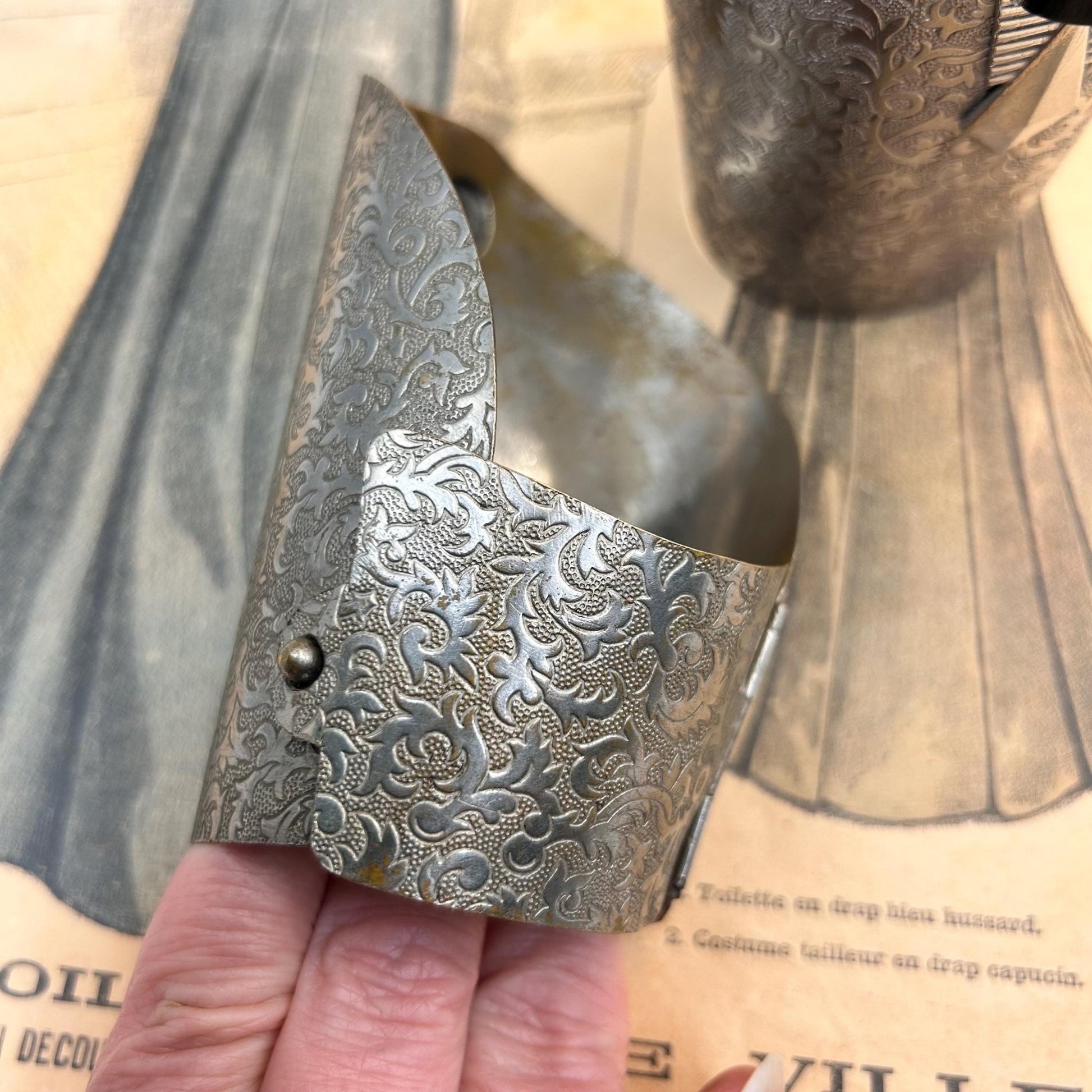 Pair of Vintage Art Deco style metal cuffs or bracelets with etched foliage pattern & applied metal & black glass detailing