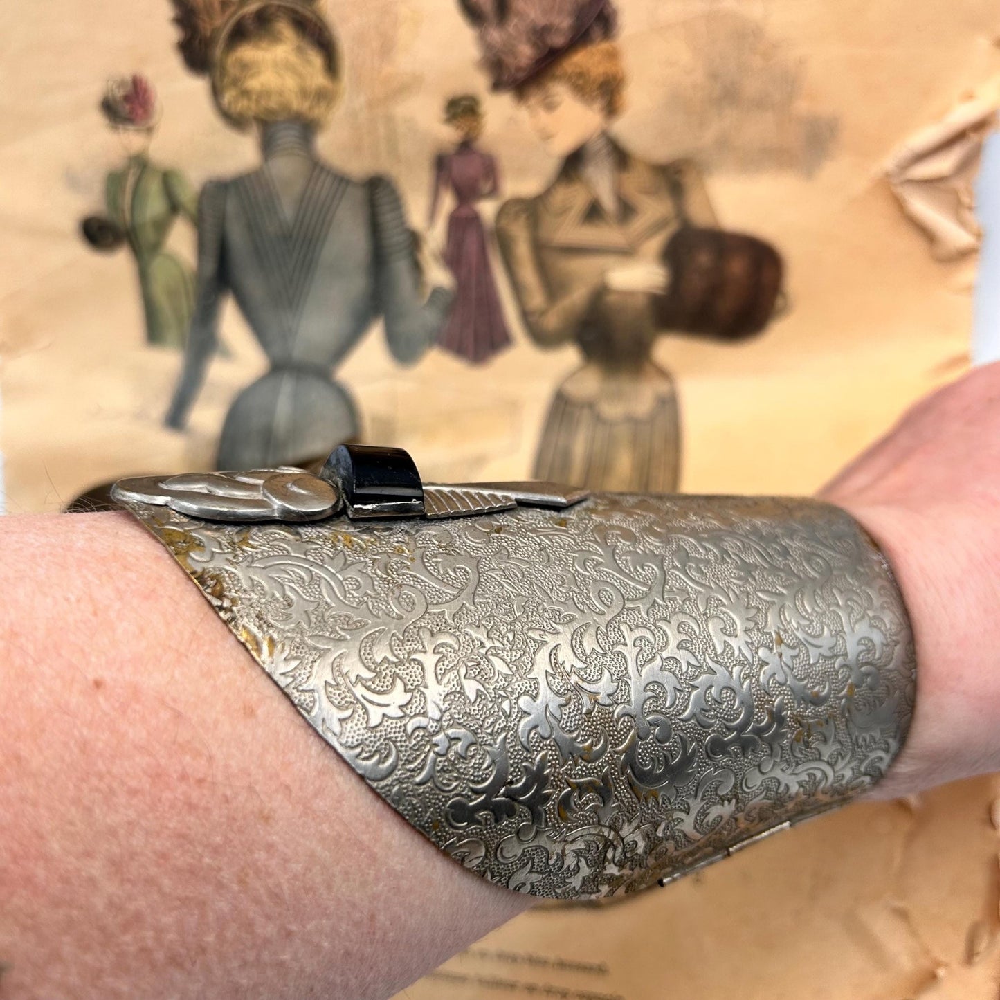 Pair of Vintage Art Deco style metal cuffs or bracelets with etched foliage pattern & applied metal & black glass detailing