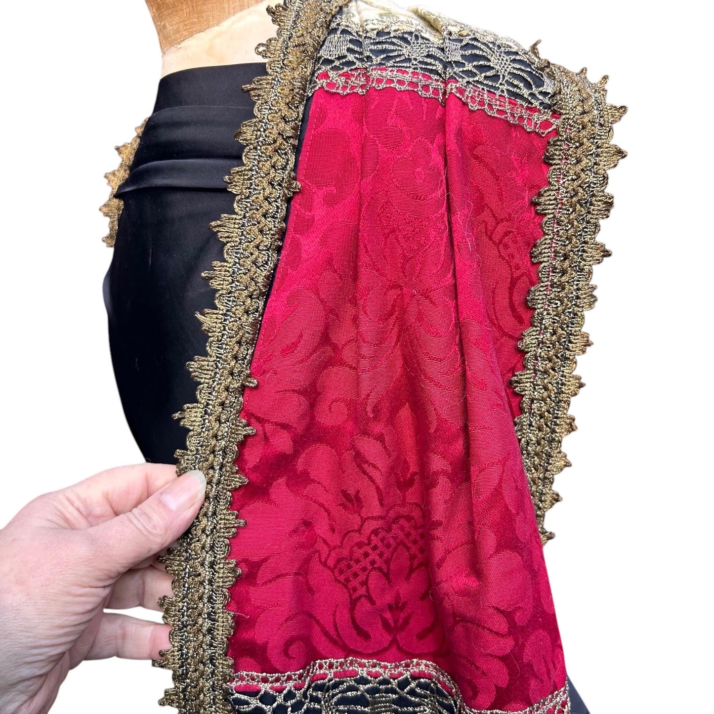 rectangular red fabric panel with Gold Trim edge held by hand against mannequin on white background - Splendid Vintage World